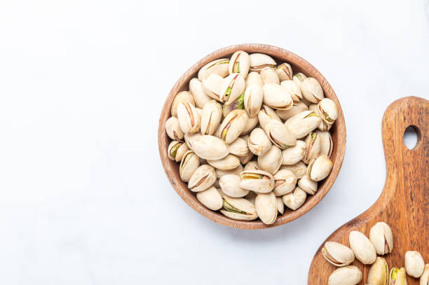 istock pistachios nuts in wooden bowl 1325652707