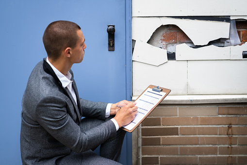 Real Estate Property Appraisal. Man Inspecting House