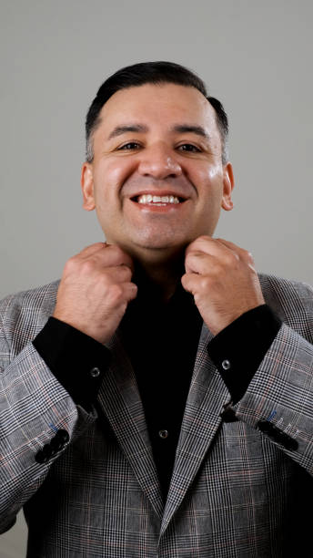 istock Smiling mature man looking at the camera on gray background 1325657335