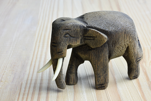 Wooden male elephant on wooden table