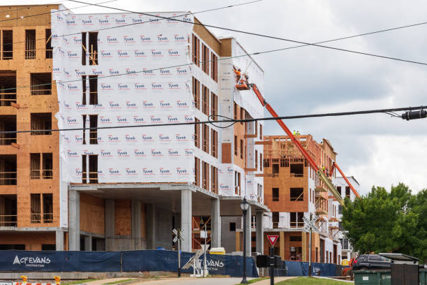 Greenville, SC, USA-23 June 2021: New construction showing wood framing and workers on skylifts.
