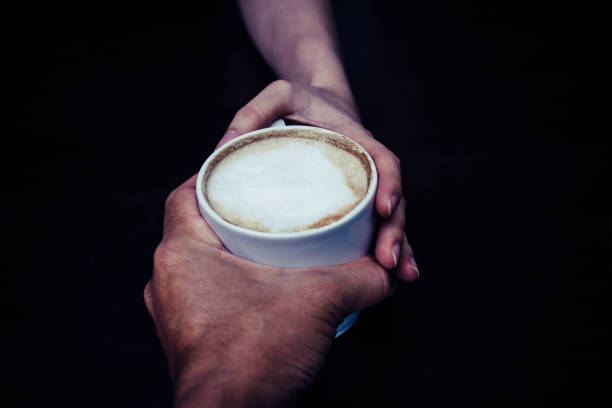 Men give coffee to a woman