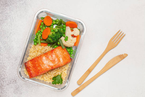 istock Salmon fillets with bulgur and vegetables in the container. Diet nutrition. Top view 1325663200