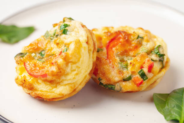 istock Egg muffins ( bites) and spinach leaves  in a plate on a gray background 1325663207