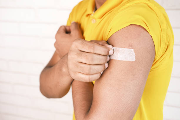 istock adhesive bandage on young man's arm 1325664011
