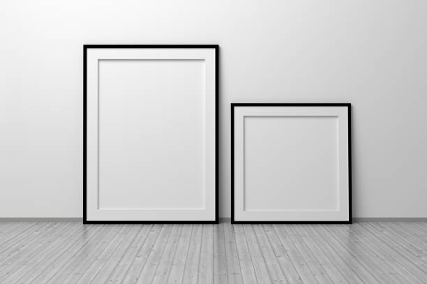 istock Mockup template of two vertical A4 frame with thin black frame border standing next to wall on wooden floor 1325666541