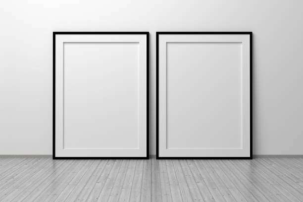 istock Mockup template of two vertical A4 frame with thin black frame border standing next to wall on wooden floor 1325667359