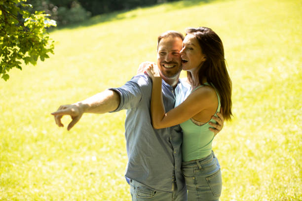 istock Affectionate young couple having fun on the green grass 1325672421