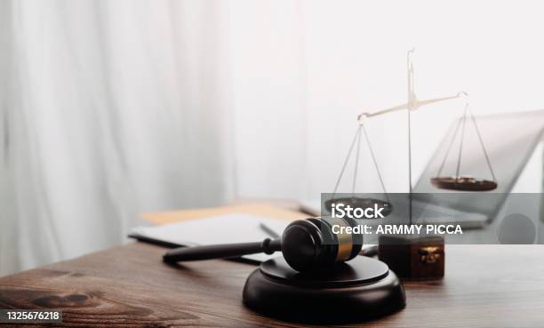 Business And Lawyers Discussing Contract Papers With Brass Scale On Desk In Office Law Legal Services Advice Justice And Law Concept Picture With Film Grain Effect Stock Photo - Download Image Now