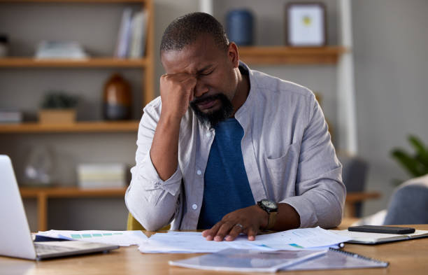 istock Shot of a mature man looking stressed while using a laptop at home 1325677916