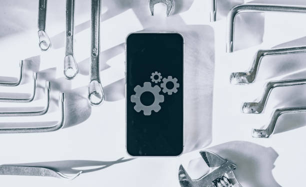 istock Repair phone. Technician workplace with phone and special repairing tools. Disassembling, diagnostic and repairman smartphone. 1325679190