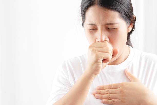 A woman has a cough, cold, sore throat, phlegm. stock photo