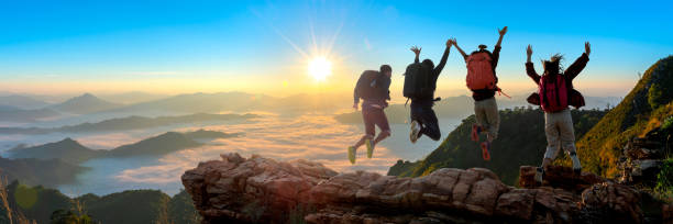 istock Group of happy hiker jumping on the hill 1325680094