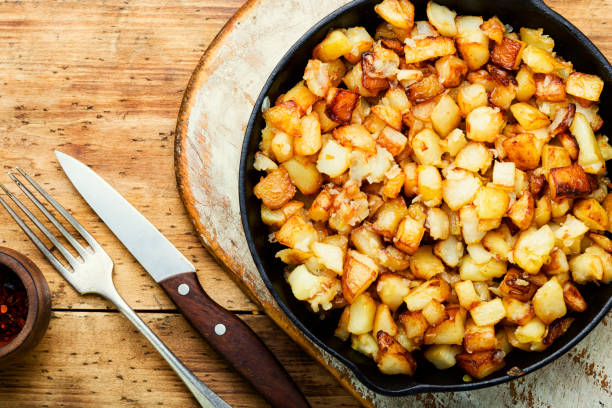 istock Baked fried potatoes in iron skillet 1325681817