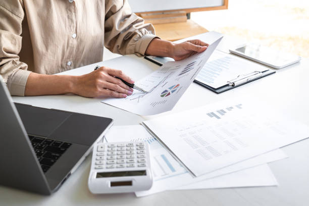istock Professional at work, business woman working and analyzing on laptop with calculate statistics of financial document data graph for new project of business strategy and market growth at workplace 1325683689