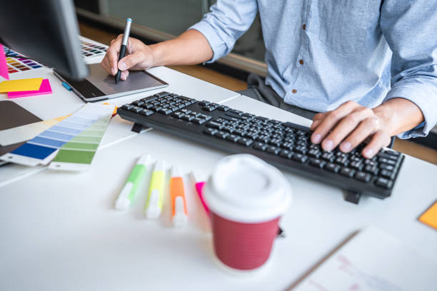 istock Image of male creative graphic designer working on color selection and drawing on graphics tablet at workplace with work tools and accessories in workspace 1325683745