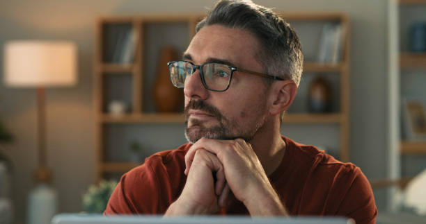 istock Shot of a mature man looking thoughtful while using a laptop at home 1325684542