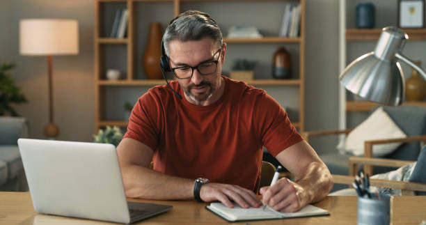 istock Shot of a mature man using a laptop and going through paperwork at home 1325684574