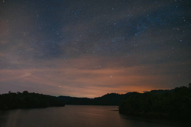 istock starry night at Kuala Kubu Dam at night with meteor 1325687911