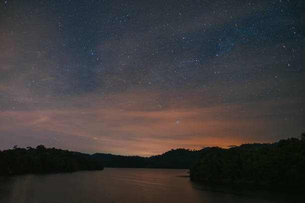 starry night at Kuala Kubu Dam at night with meteor starry night at Kuala Kubu Dam at night with meteor dam photos stock pictures, royalty-free photos & images