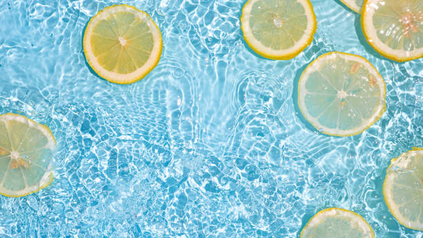 istock Lemon slices in clean transparent water, blue bg 1325688166