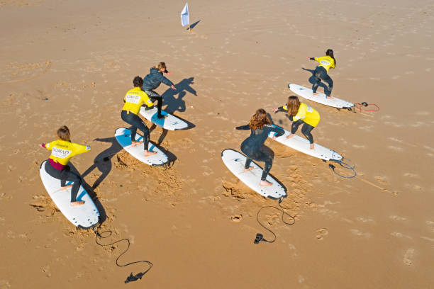 Vale Figueiras, Portugal - January 2, 2021: Surfers getting surflessons at Vale Figueiras beach in Portugal