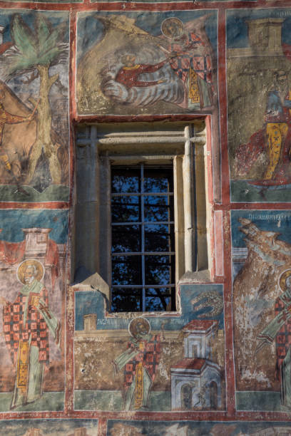 istock Painted wall at Monastery Humor, Romania ,2017,october Old window with bars 1325691894