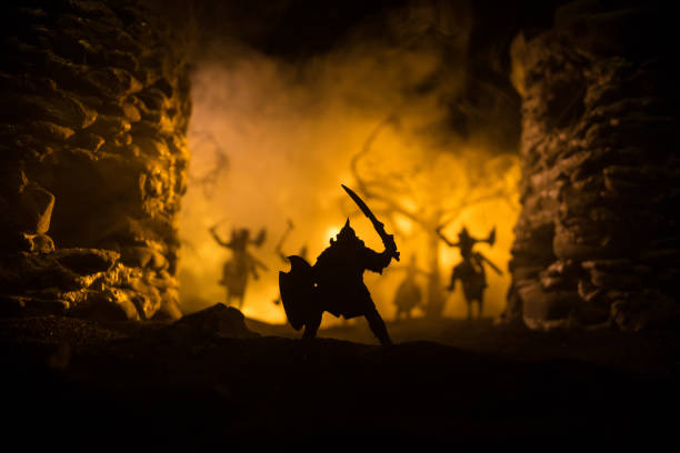 istock Medieval battle scene with cavalry and infantry. Silhouettes of figures as separate objects, fight between warriors on dark toned foggy background with medieval castle. 1325694799