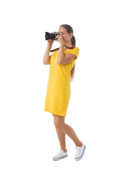 istock Girl with camera on white 1325696594