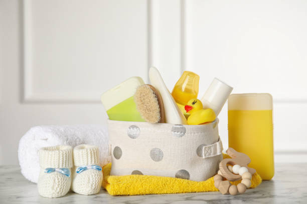 istock Baby booties and accessories on white marble table indoors 1325697441