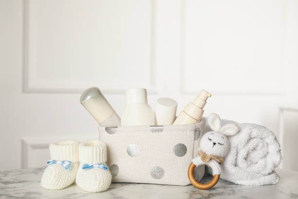 istock Baby booties and accessories on white marble table indoors. Space for text 1325698800