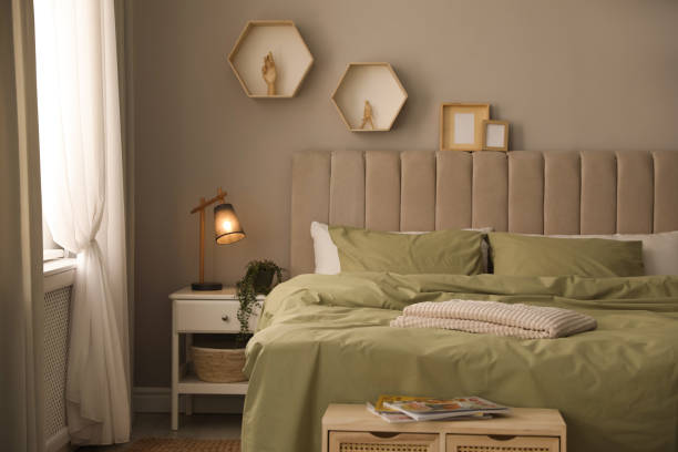 istock Large comfortable bed with beautiful linens in room 1325699789