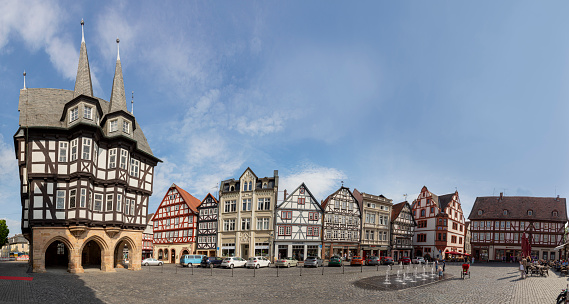 Alsfeld, Germany - June 25, 2021: famous town hall and half timbered historic houses at central square in Alsfeld, germany.