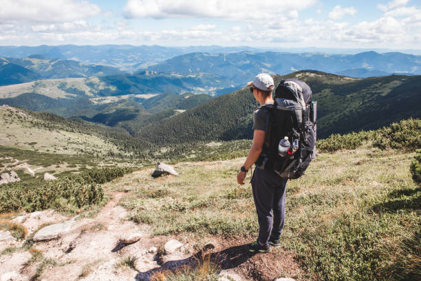 istock young hiker man in mountains. summer trekking path 1325700969