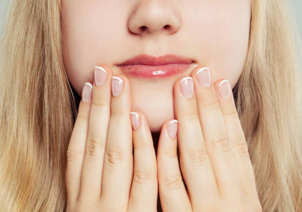 Short manicured nails. Hands with french manicure close up