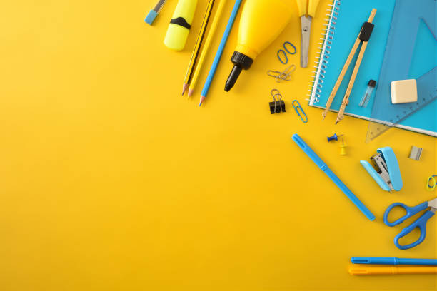 istock Yellow and blue school supplies on yellow top diagonal composition 1325702420