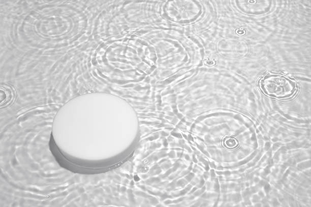 istock Empty white circle podium on transparent clear water background with copy space 1325703300