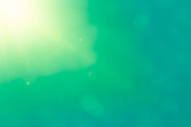 beam of light on a bright green background with a bokeh.