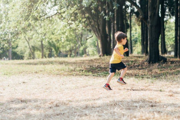 Little boy running in the forest