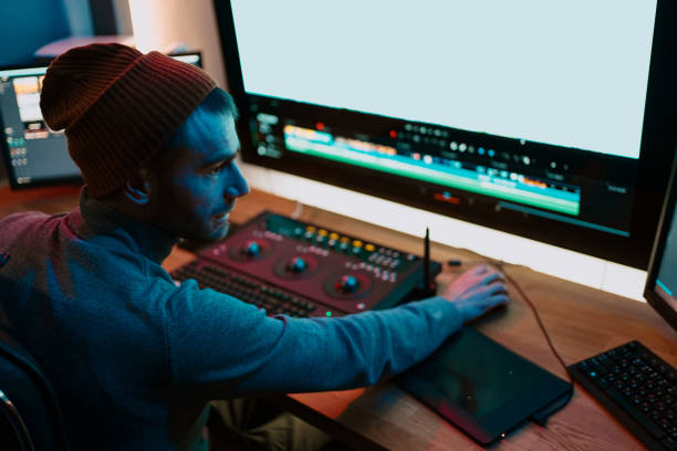 istock Male Video Editor Working on His Personal Computer with Big blank Display 1325708897