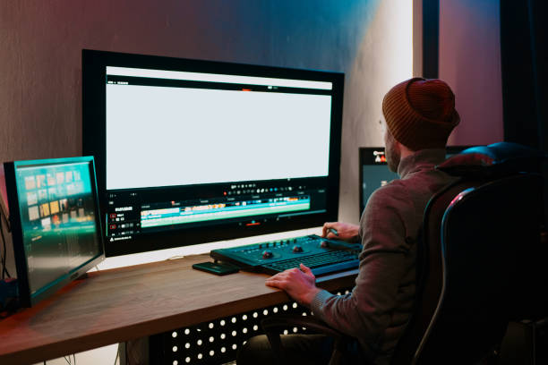istock Male Video Editor Working on His Personal Computer with Big blank Display 1325708907