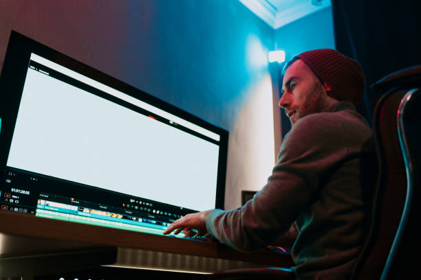 istock Male Video Editor Working on His Personal Computer with Big blank Display 1325708915