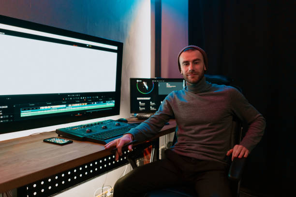 istock Male Video Editor Working on His Personal Computer with Big blank Display 1325709130