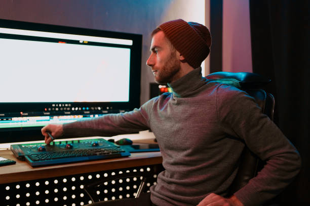 istock Male Video Editor Working on His Personal Computer with Big blank Display 1325709160