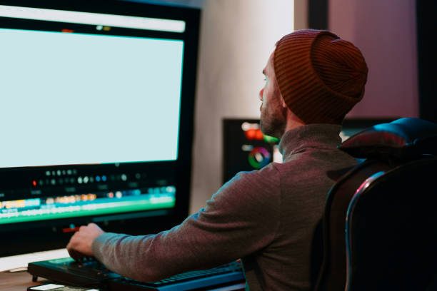 istock Male Video Editor Working on His Personal Computer with Big blank Display 1325709209