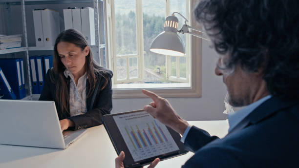 istock Businesspeople co-working on project in office, brainstorming. Sustainable development goals-working in a paper free office space. 1325709359