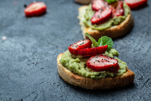 tosty z puree z awokado, truskawki i nasiona chia, awokado z truskawkami. keto tosty diety. wegańska koncepcja zdrowej żywności. widok z góry - toast bread berry appetizer zdjęcia i obrazy z banku zdjęć