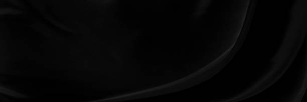istock Black gray satin dark fabric texture luxurious shiny that is abstract silk cloth panorama background with patterns soft waves blur beautiful. 1325714489