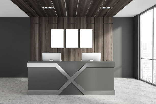 istock Minimalistic dark office interior design with reception counter and posters 1325715543