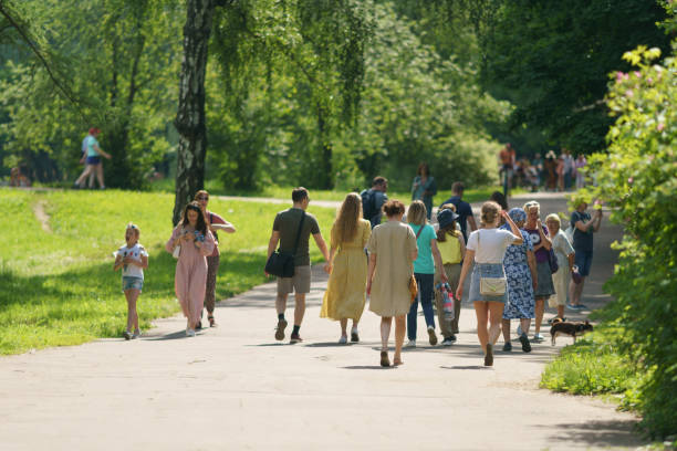 Moscow, Russia - June 14, 2021: Russian people of different generations walking in the public park in hot summer day. A lot of people. Leisure concept.